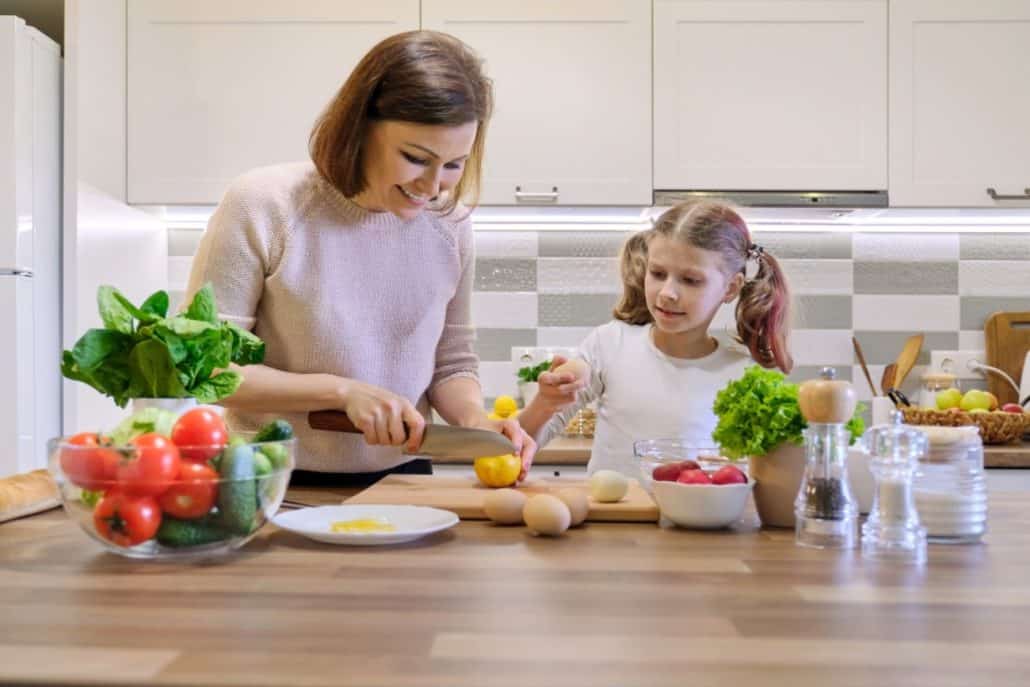 Mother teaches daughter to cook