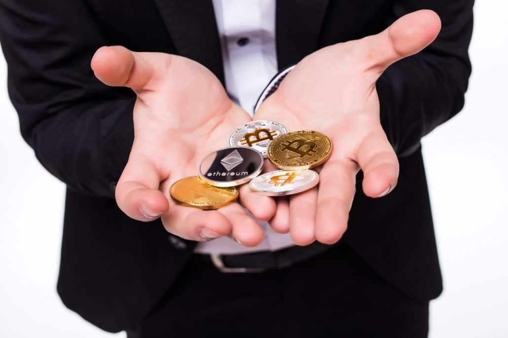 Man Holding Different Cryptocurrencies