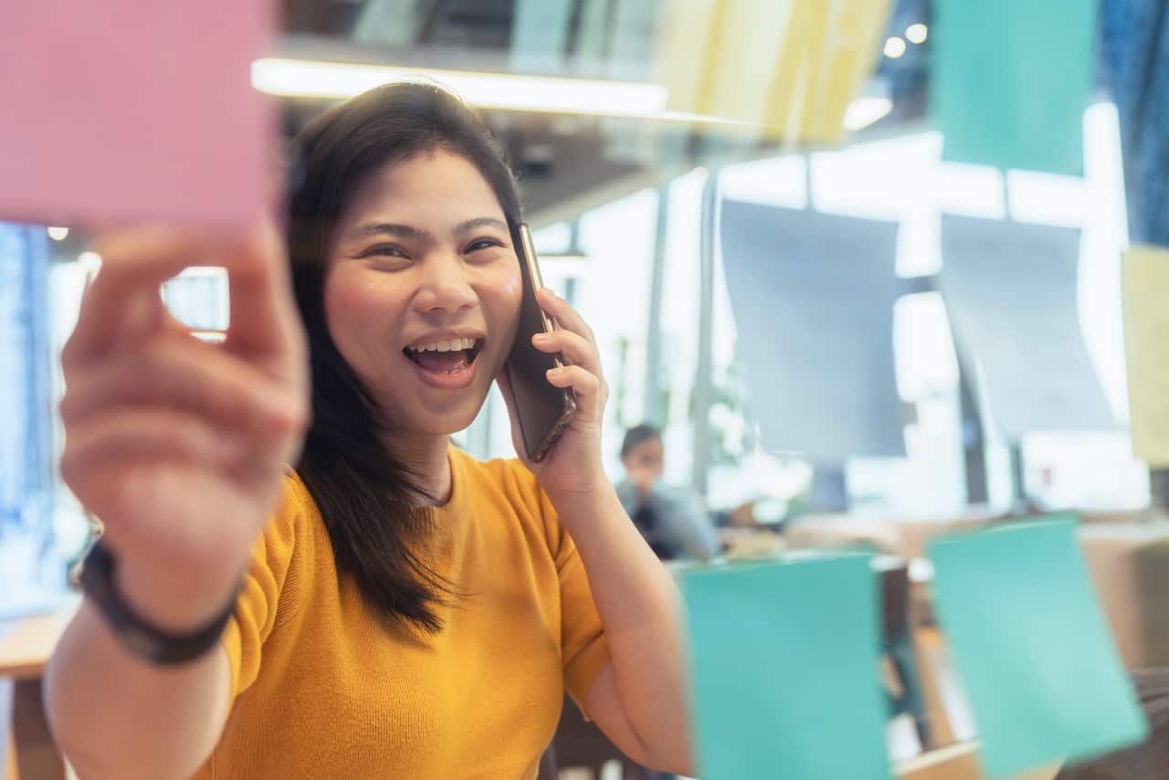 freelance asian female on the phone smile