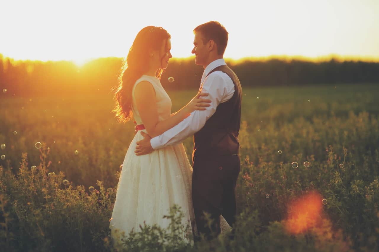 bride groom hugging each other at a sunset