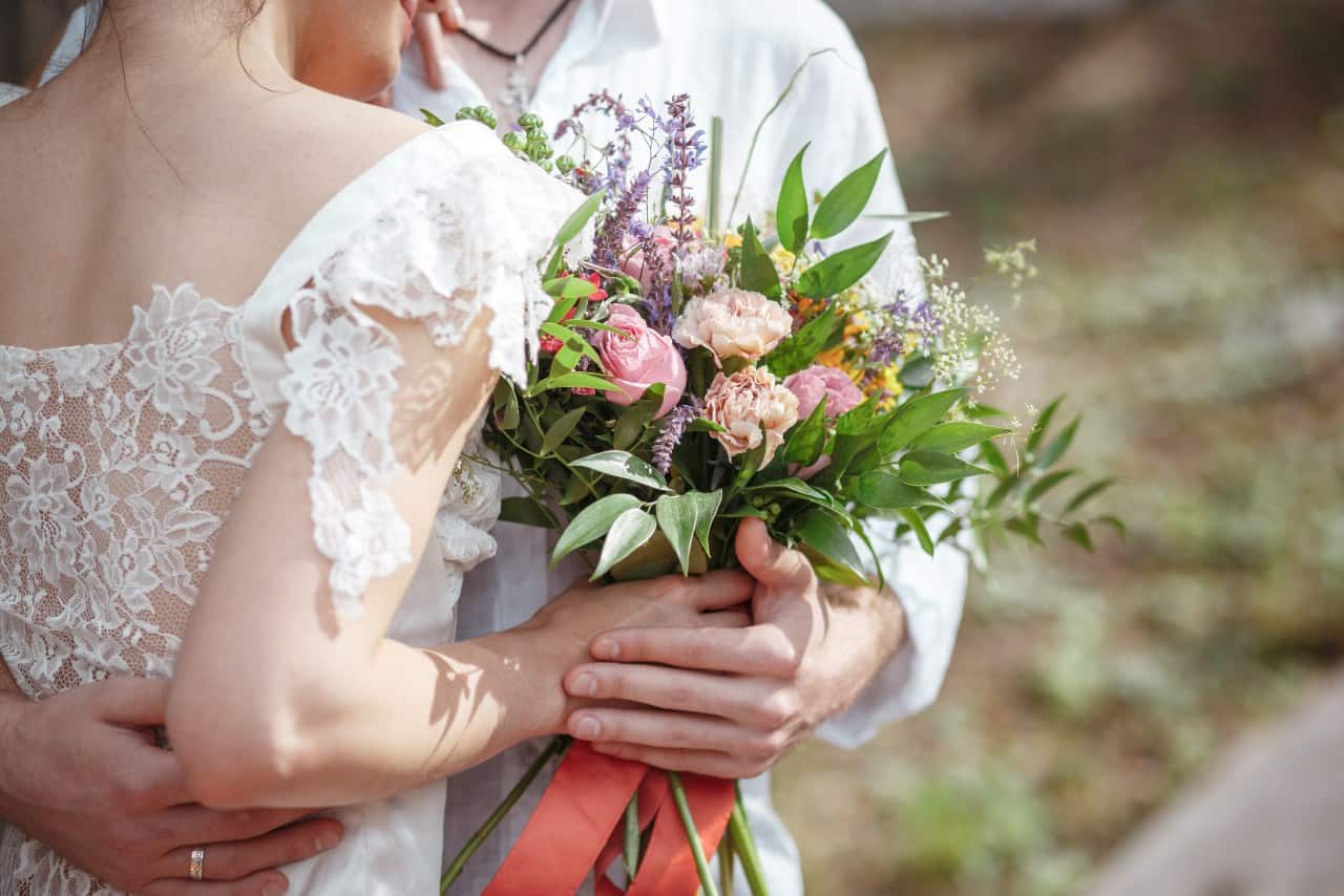 wedding hand holding flowers woman dress