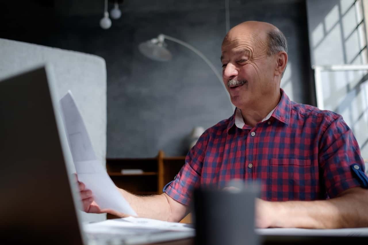 man selecting retirement plan from paper