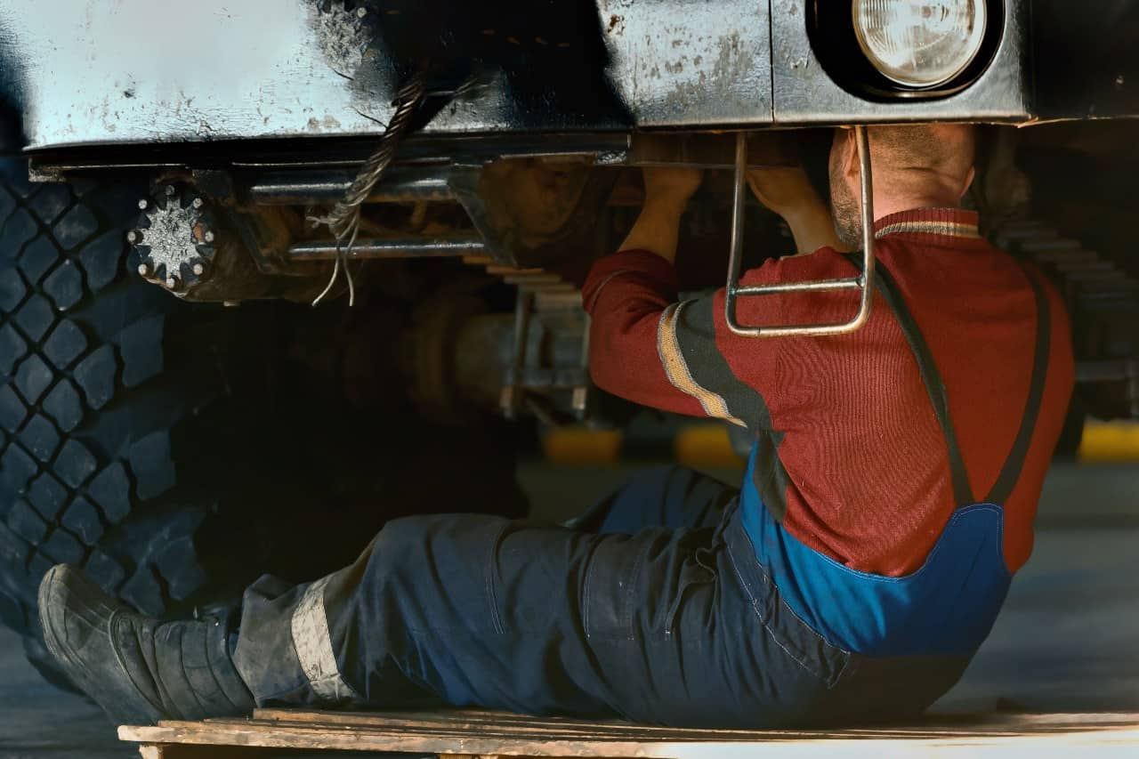 car mechanic fixing under the car dirty