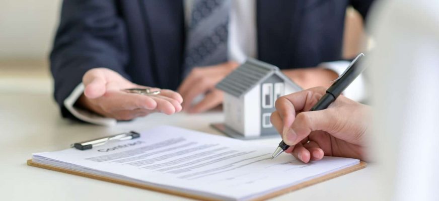 man signing secured loan contract
